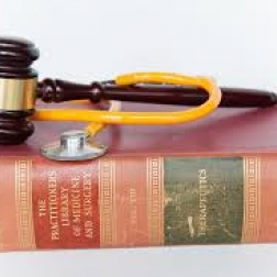 gavel and stethoscope on top of medical law book