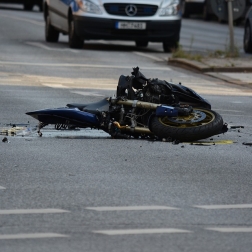 Wrecked motorcycle laying on the road