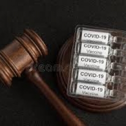 gavel and block next to COVID vaccine vials